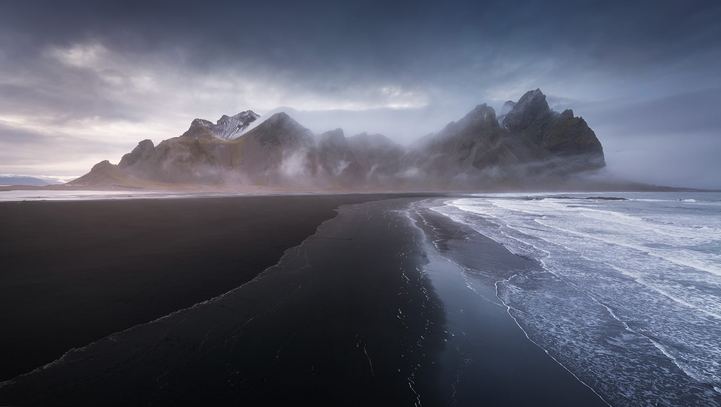 Black sand and wild mountains on Iceland’s coast